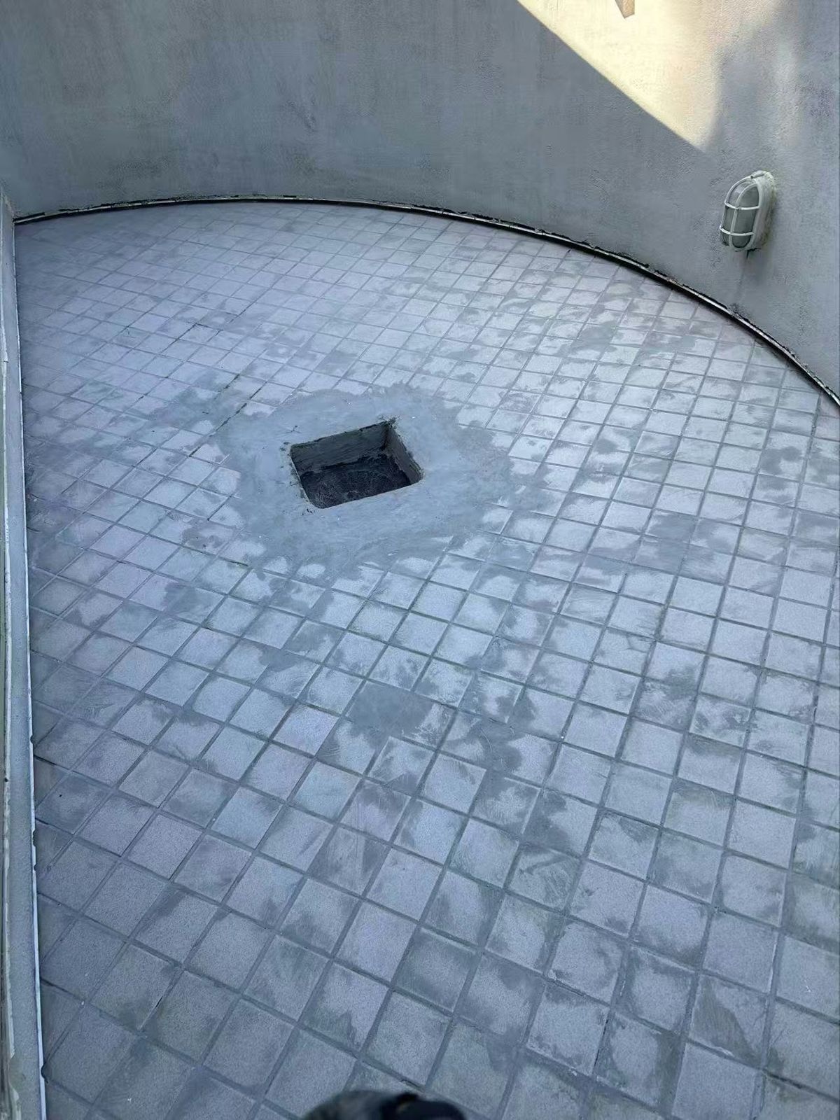 Before: Tiled curved balcony re-done in vinyl, new drain